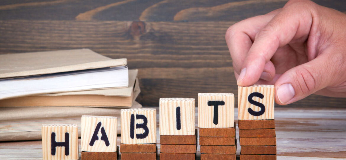 Habits concept. Wooden letters on the office desk, informative a