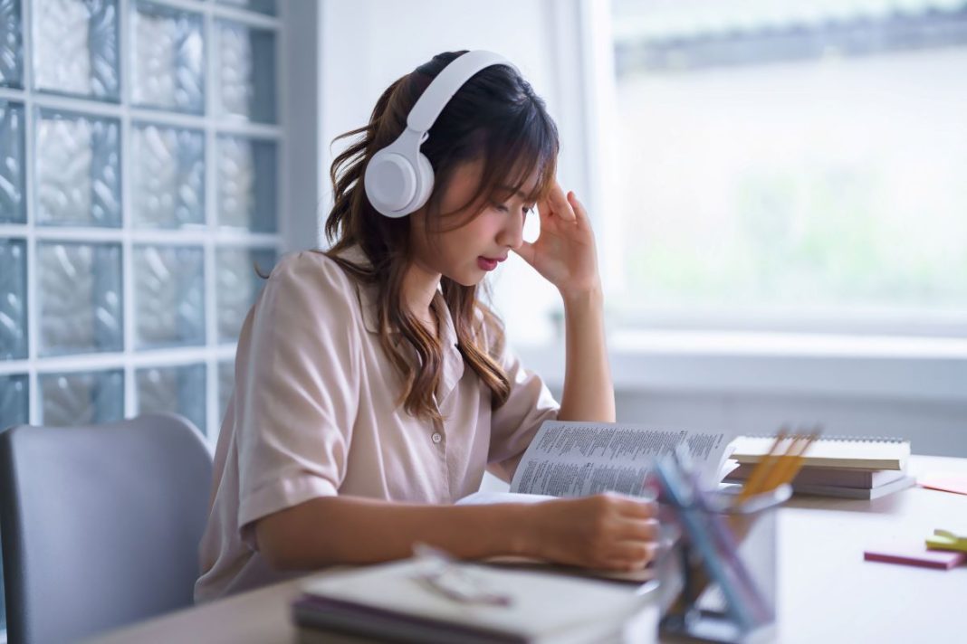 law student wearing headphones while studying
